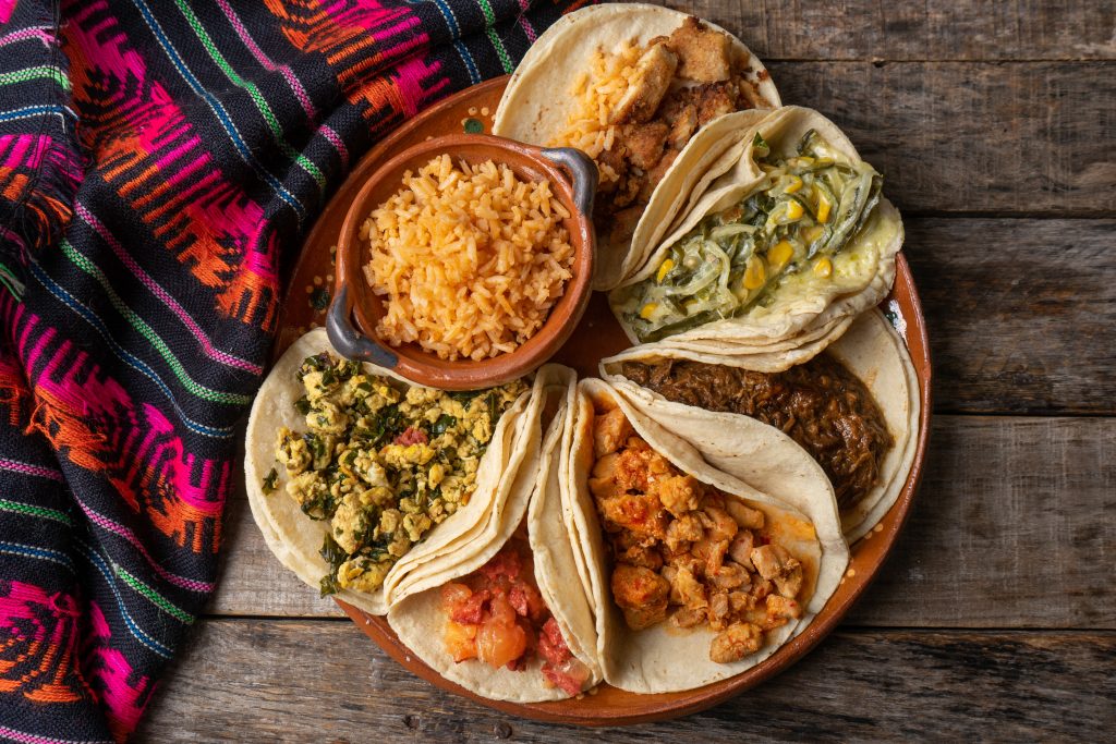 Traditional Mexican stew tacos also called "guisados" with rice