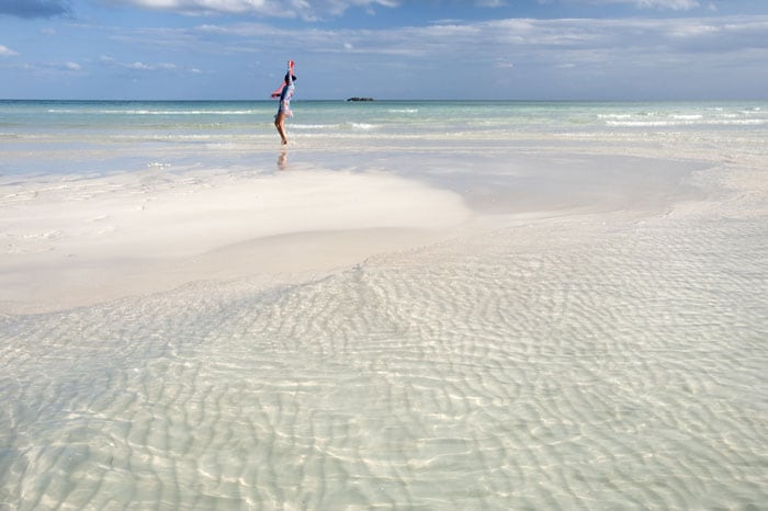 woman dancing on a bahamian beach in freeport