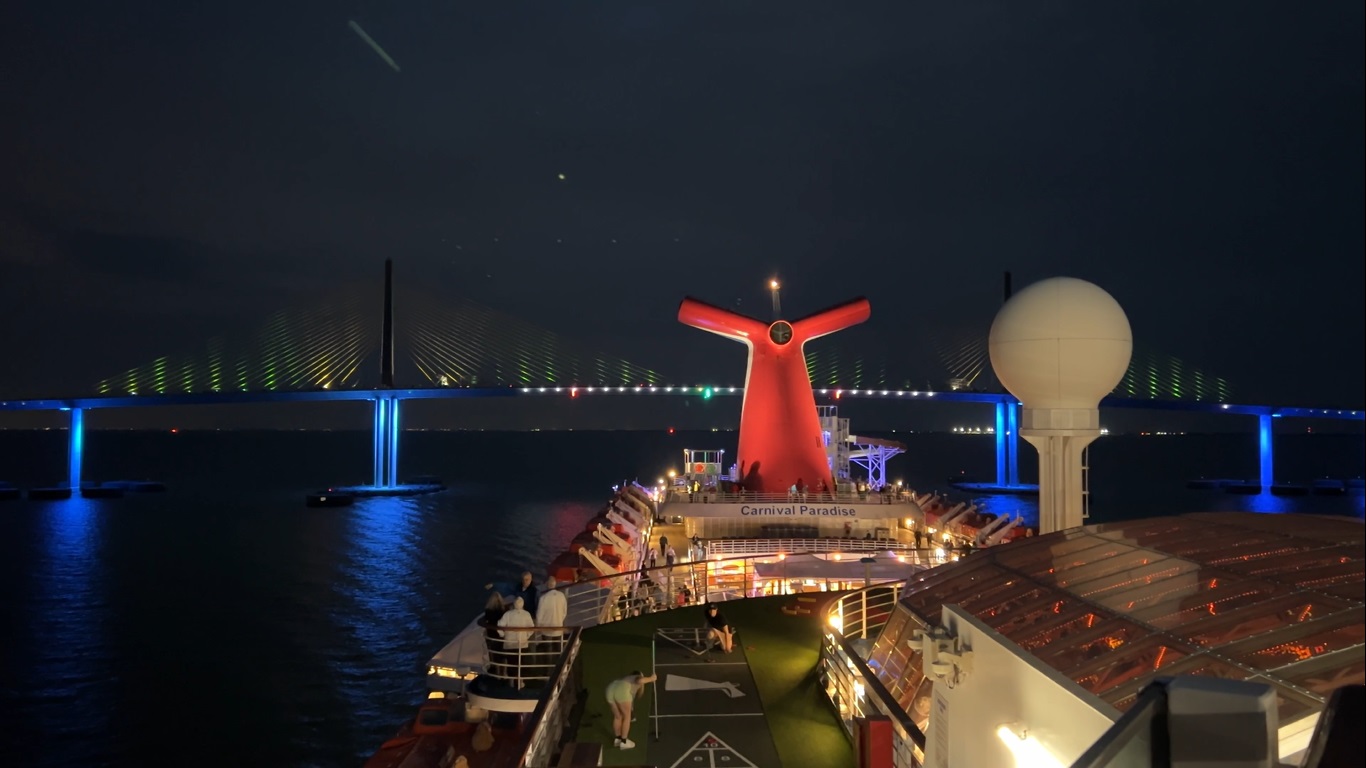 Cruise Ports – Carnival Paradise Passes Under Sunshine Skyway Bridge After Dark While Leaving Tampa